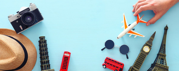 holidays image of traveling concept with accessories and world symbols over blue background. top view, flat lay © tomertu