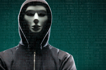 Dangerous hacker over abstract digital background with binary code. Obscured dark face in mask and hood. Data thief, internet attack, darknet fraud, virtual reality and cyber security.