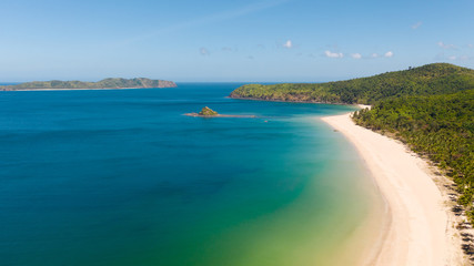 aerial view island with tropical sandy beach and palm trees. Malajon Island, Philippines, Palawan. tourist boats on coast tropical island. Summer and travel vacation concept. beach and blue clear sea
