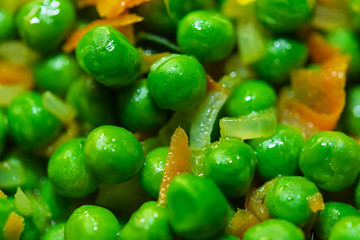 Fresh green peas with carrot. Vegetables for frying on a frying pan. Closeb up. Selective focus.