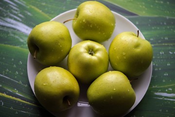 Green apples on a green background