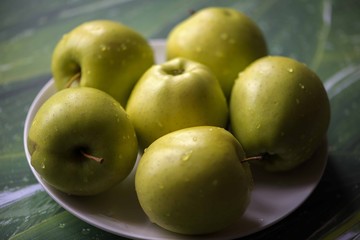 Green apples on a green background