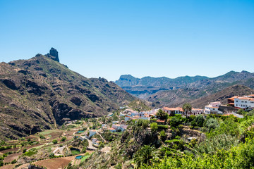 Fototapeta na wymiar lanscape view of small spanish town of Tejeda in gran canaria island on mountain valley on summer day with view of bentayga rock