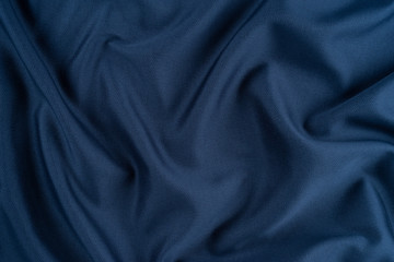 Bright blue fabric texture with folds.