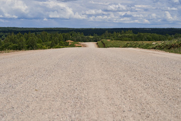 Wide gravel road going to the horizon
