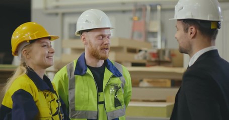 Factory workers giving high five - Powered by Adobe