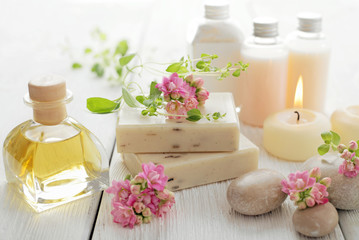 spa still life with essential oil, soap bars and aromatherapy candles