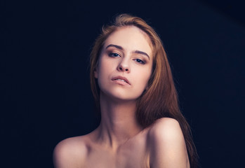 Fototapeta premium close up. portrait of a beautiful young woman . isolated on black