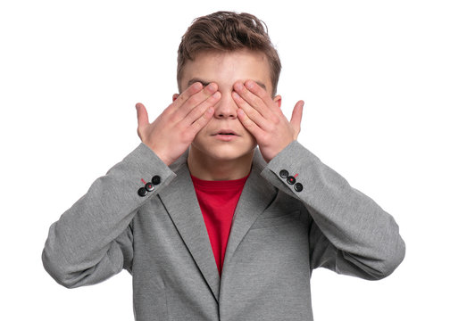 I Do Not See, Do Not Speak, Can Not Hear Anything - Portrait Of Young Caucasian Teen Boy. Funny Teenager 14 Year Old. Handsome Child In Suit Isolated On White Background.