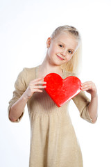 Beautiful girl holding heart in arms.