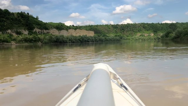 The front of the boat in the river. Rafting on a catamaran along the wide canyon of the Dniester River. Cloudy weather, beautiful landscape.