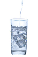 pouring mineral water in transparent glass with ice and bubbles isolated over white background, close up