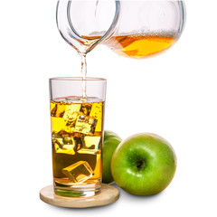 glass with ice and pouring apple juice decorated fruits on stone isolated over white background, concept of refreshing summer drink