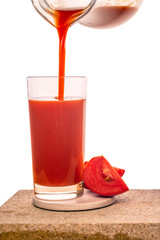 pouring tomato juice in transparent glasses decorated vegetables isolated on white background