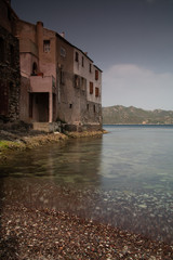 Fototapeta na wymiar Houses built near the water, in the village of Saint Florent, Corsica