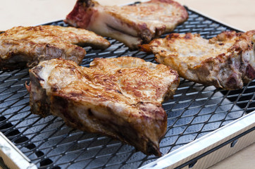 Closeup of tasty and juicy roasted pork meat on grill