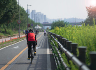 Cyclist with red jersey and black bike.
