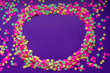 Frame of multicolored confetti in on a dark background