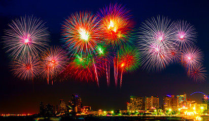 Fototapeta premium Beautiful colorful fireworks display on the sea beach, Amazing holiday fireworks party or any celebration event in the dark sky.