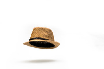 At the Drop of a Hat. A straw panama hat falling against a white background.
