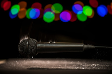 Mic Drop! A microphone falling onto a stage floor.