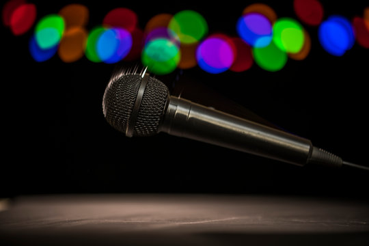 Mic Drop! A microphone falling onto a stage floor.