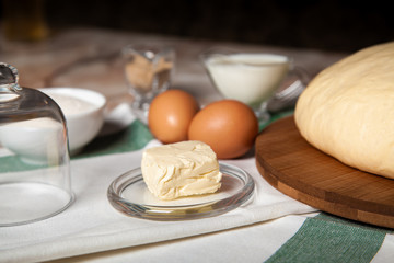 Bakery ingredients. On the table are butter, eggs, milk, yeast, sugar