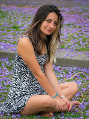 A woman on the grass with flowers around