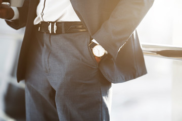 Confident Businessman Wearing Wristwatch, Holding Hand in Pocket