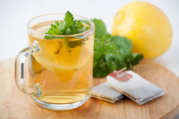 Green tea with mint and lemon in a glass mug
