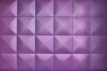 Background consists of large purple squares. Rhombic purple color wall of big squares. Unusual, beautiful and modern background.