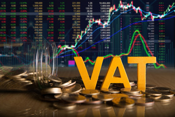Vat Concept.Word vat put on coins and glass bottles with coins inside on black background.Stock market or forex trading graph and candlestick chart - obrazy, fototapety, plakaty
