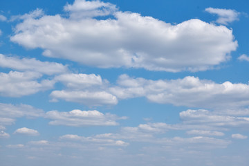 The sky on a Sunny summer day. Background clouds on blue sky. White Cumulus clouds in clear weather.