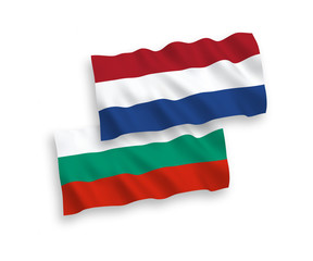 Fototapeta premium National vector fabric wave flags of Bulgaria and Netherlands isolated on white background. 1 to 2 proportion.