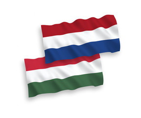National vector fabric wave flags of Netherlands and Hungary isolated on white background. 1 to 2 proportion.
