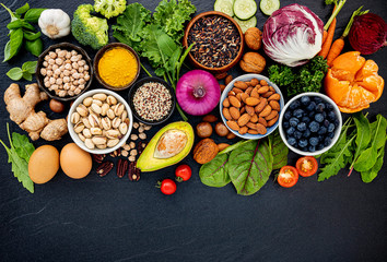 Ingredients for the healthy foods selection. The concept of healthy food set up on dark stone background.