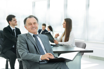 successful businessman with documents on the background of the office