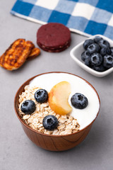 Granola, oatmeal with milk, peach and blue berry