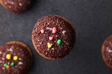 Chocolate Crinkle cookies. close-up of Crinkle cookies chocolate biscuits on Christmas cookies on a black plate, view from above.