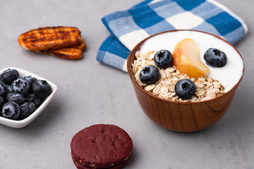 Granola, oatmeal with milk, peach and blue berry