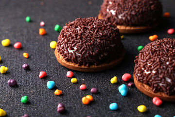 Chocolate Crinkle cookies. close-up of Crinkle cookies chocolate biscuits on Christmas cookies on a black plate, view from above.
