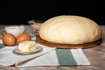 Bakery ingredients. On the table are flour, eggs and pastry dough