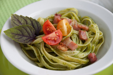 Pasta with pesto, cherry tomatoes and basil