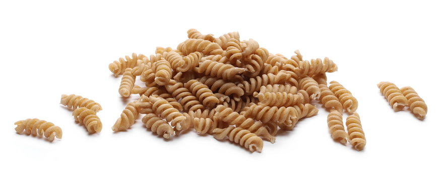 pile integral wholemeal pasta fusilli isolated  on white