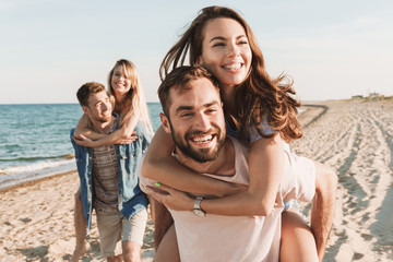 Group of happy friends spending time together at the beach