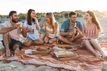 Group of happy friends spending time together at the beach
