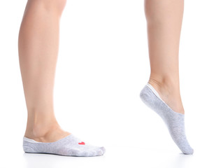 Female feet in gray no show socks on white background isolation