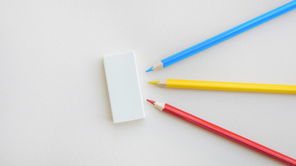 Bright pencils lying near rubber