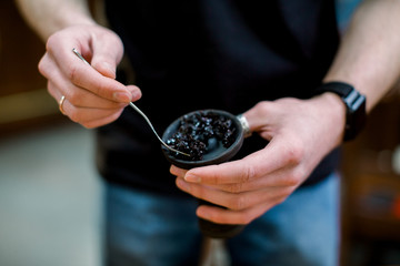 Shisha hookah preparing by two barmans. Bartender lays tobacco for smoking