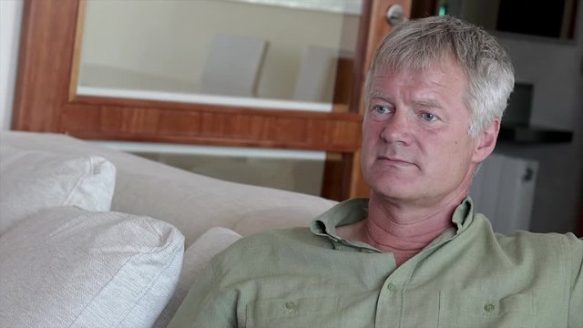 Middle-aged handsome man at home front of the camera